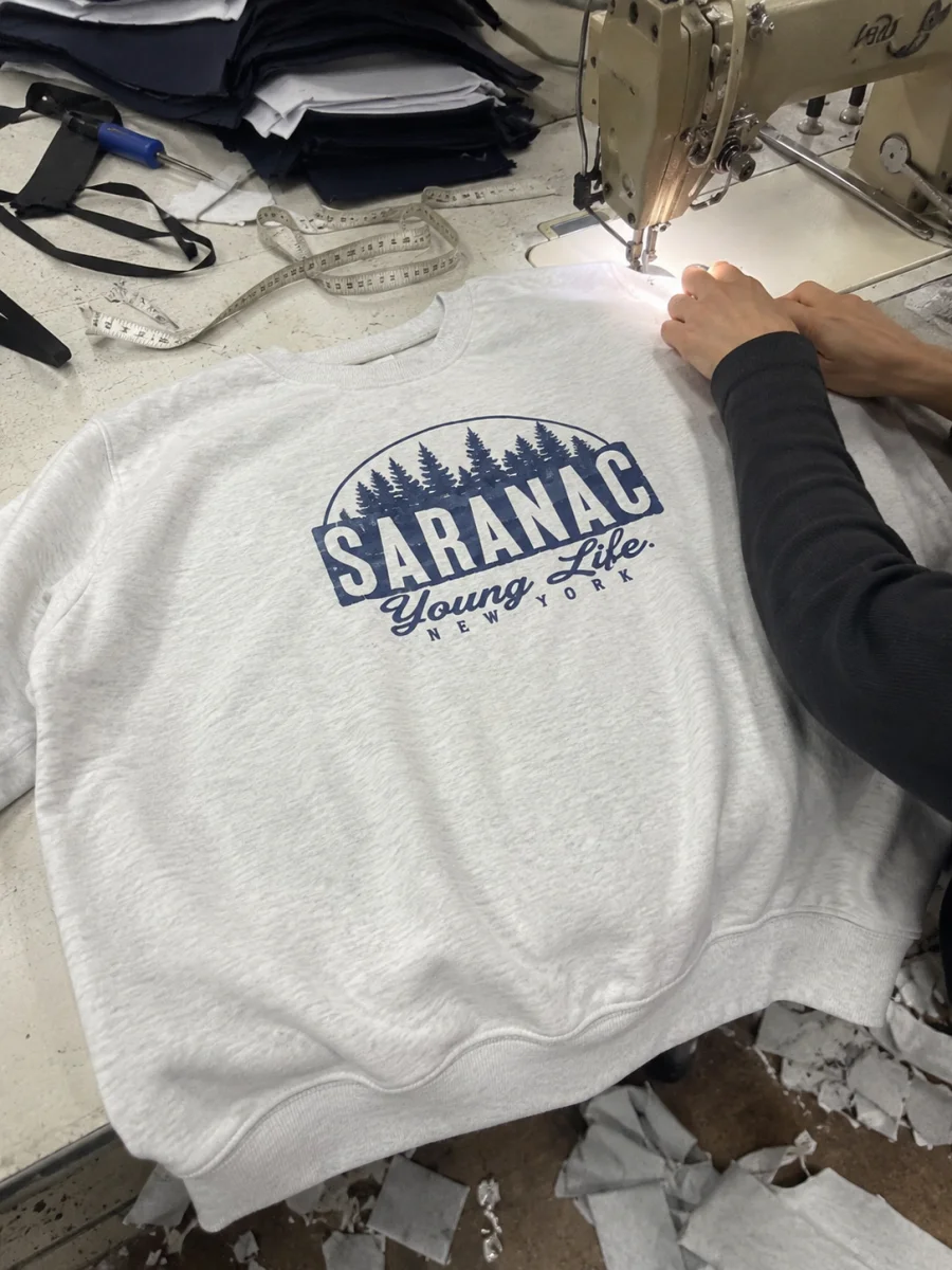 Close-up of a custom design being embroidered in the Aim High production shop