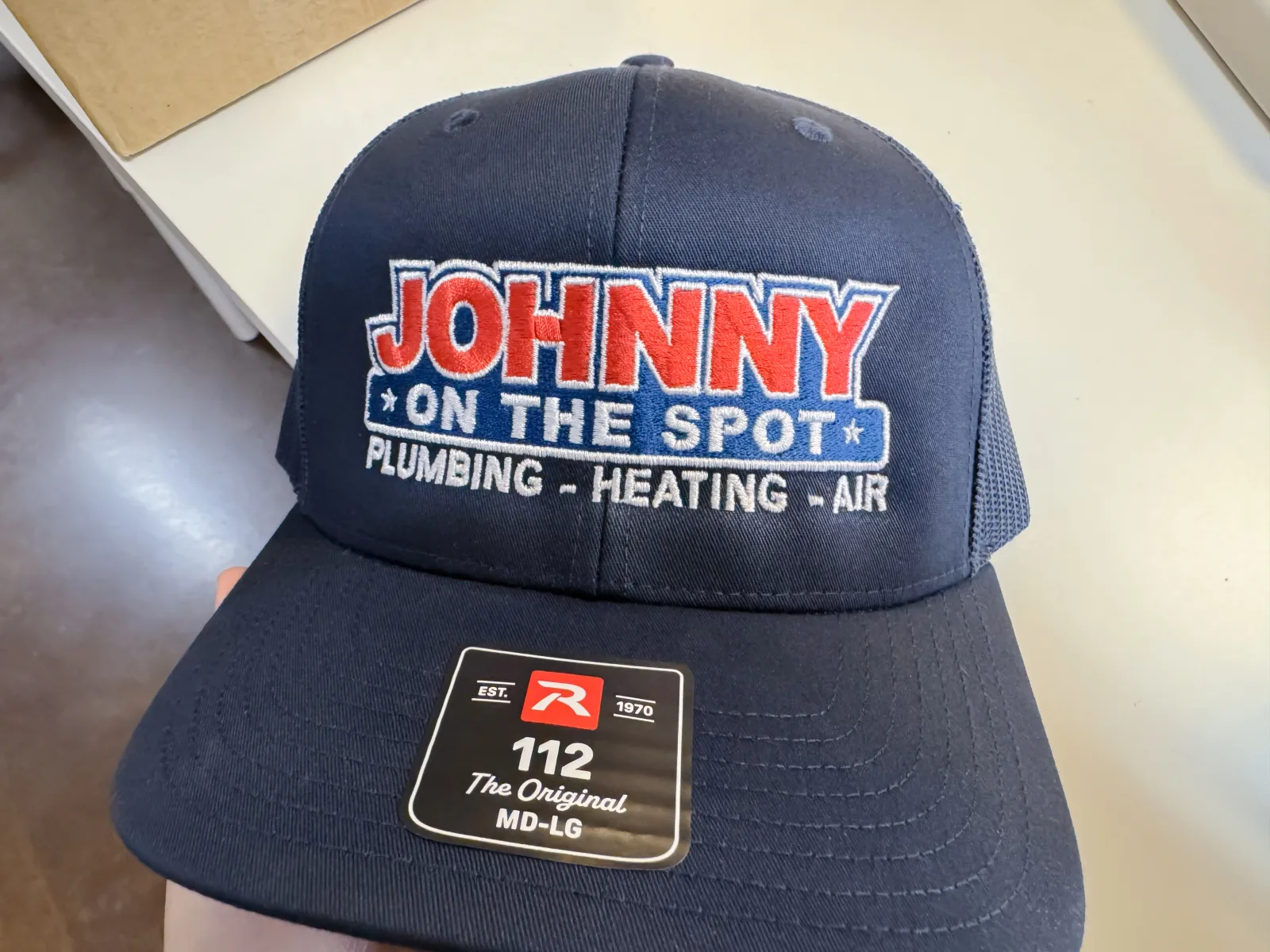 Embroidered trucker hat for Johnny on the Spot Plumbing, Heating & Air